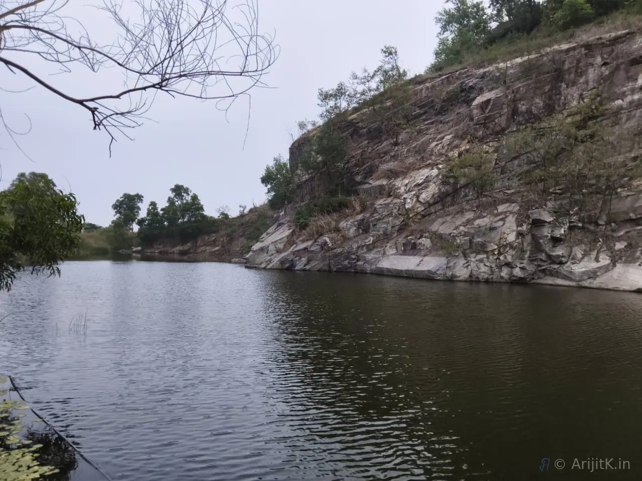 Steep rocky cliff face alongside a flowing river