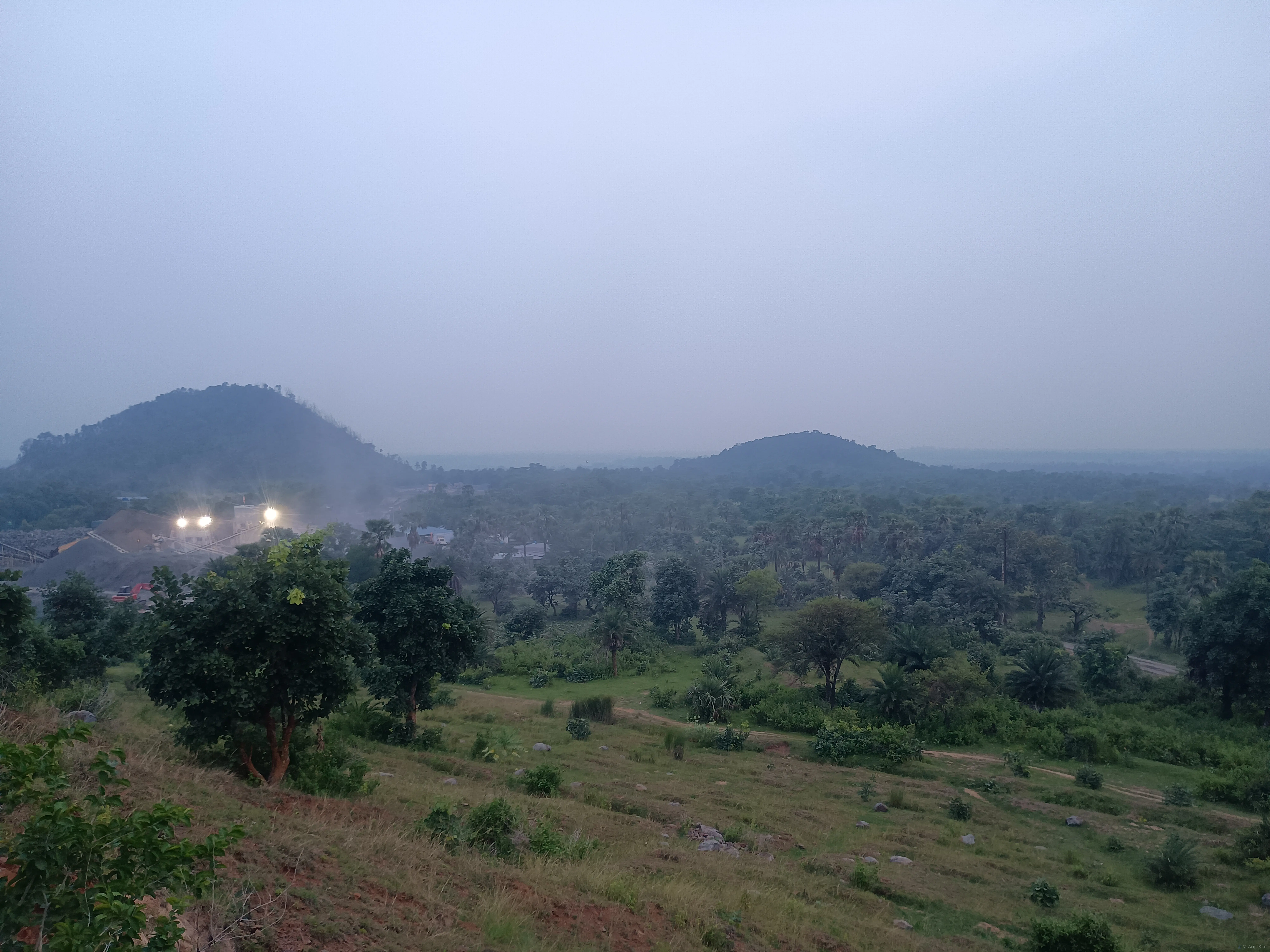 Rocky hillside at Paharpur with sparse vegetation