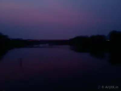 The Dwarakeswar River flowing through the countryside at dusk